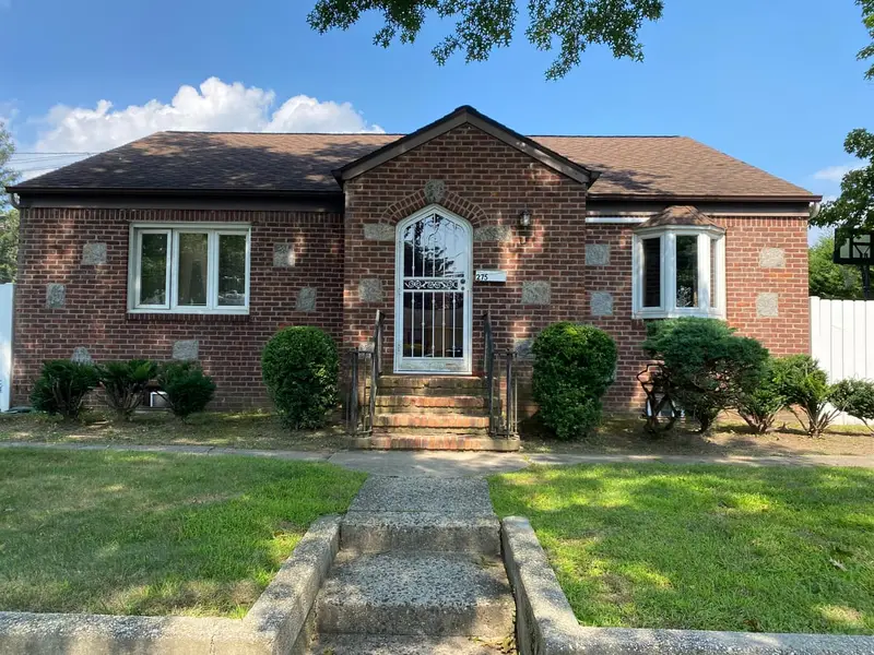 Brick ranch with an arched front door and brick steps, Plainview, NY